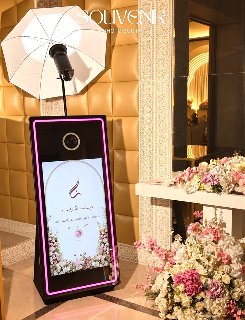 Illuminated mirror booth with a floral wedding frame